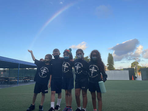 Five kids posing on a field